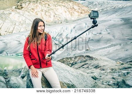 Young Woman Hiking in the Swiss Alps, Taking a Selfie.