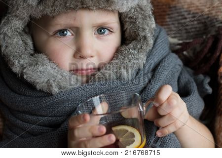 Portrait of a Sick Child with Tea. Copy Space