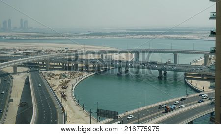 Aerial View On Traffic Bridge Over River In Sunny Autumn Day Cars On Bridge. View Of Traffic Jam On 