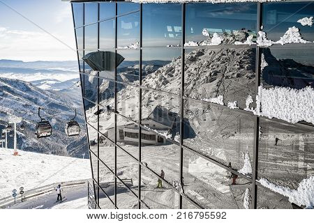 Reflection of hill Chopok on building of ropeway in snowy Low Tatras mountains Slovakia
