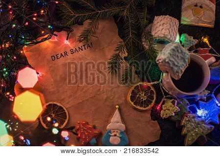 Letter for Santa on decorated chrismas background with gingerbread coocies and garland