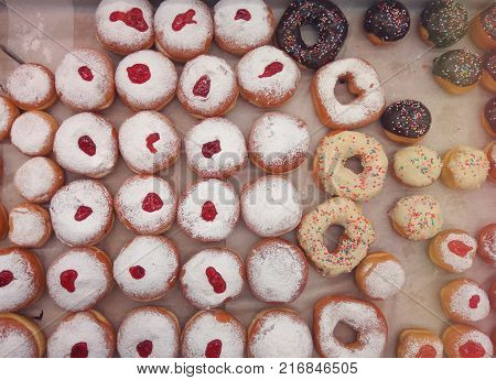 Festive sweet donuts are traditional symbols of Hanukkah holiday