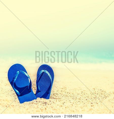 Summer Holidays in Beach Seashore. Summer vacation concept in vintage hipster style with blue flip flops