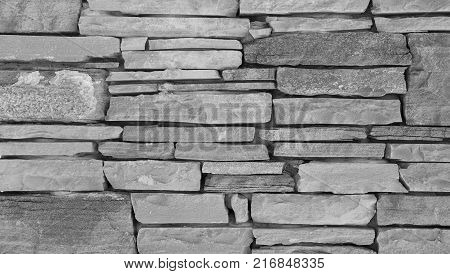 Stone wall texture slim briks. Gray brick wall background.