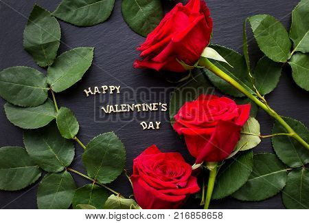 Gift by St. Valentine's Day, heart from threads and a red greeting card with an inscription of Happy Valentines day on a fabric linen backgroundThe inscription Happy Valentine on a black background with red roses