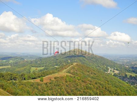 Paragliders flying above the Malvern Hills in Worcestershire
