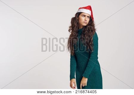 woman in green dress blows her lips, light background, free space for copy, new year, holiday.