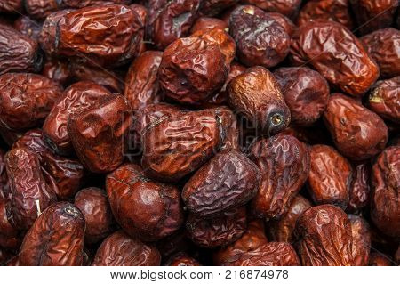 Close up raw organic medjool dates ready to eat. Background of date palm texture.