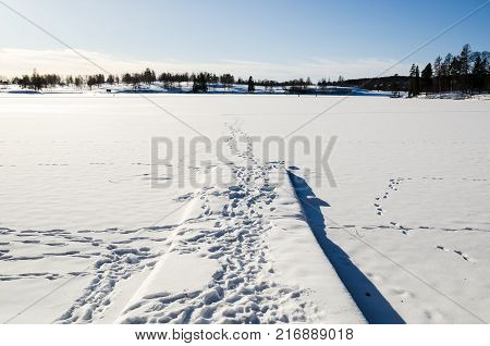Jetty in frozen lake covered by snow in Bogstadvannet Oslo Norway. Tranquility and peace