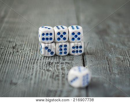 Dice blue and white color on wooden rustic table. Accessories for Board games.