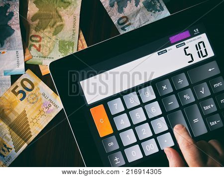 Counting money on a calculator, azerbaijan manat