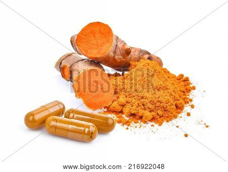 turmeric root and powder with turmeric capsules isolated on white background