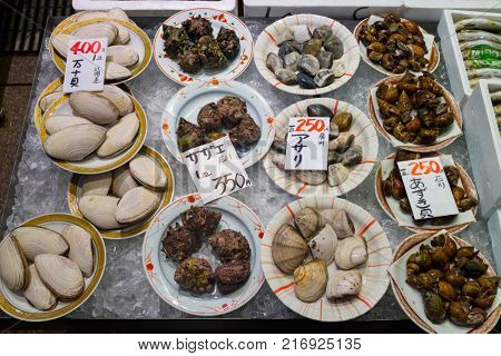 Kanazawa - Japan, June 8, 2017: Dishes with fresh diversity of sea shells on ice and price tags at the Omicho Market 