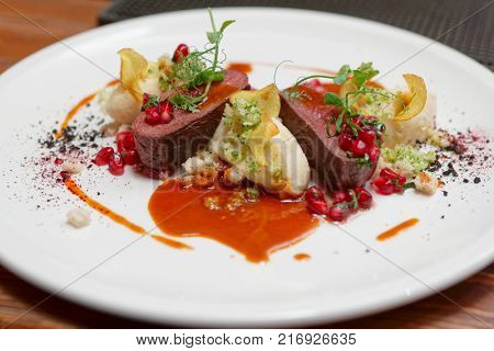 Venison fillet and potato puree on white plate