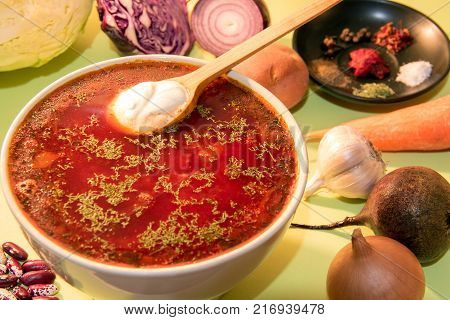 Ukrainian red vegetable soup with sour cream. Traditional beetroot soup.