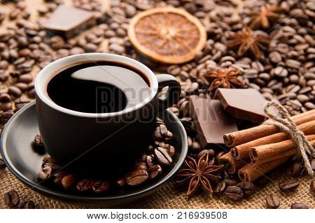 Yin and Yang in a Coffee cup on a saucepan with barley cinnamon and chocolate