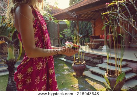 Woman Holding Canang Sari - Offering For Gods. Balinese Tradition.