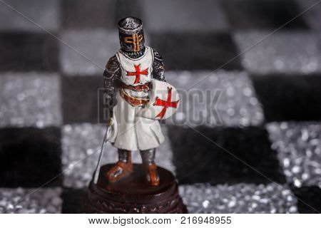 Pewter chess piece Bishop (or knight) alone on the Board.
