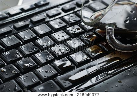 Liquid spilled on a computer keyboard close-up