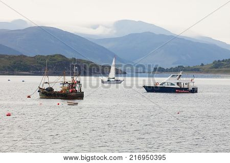 Ullapool, Scottish Highlands, Scotland, United Kingdom. Quaint Village And Loch Broom, Beneath Mountain Range