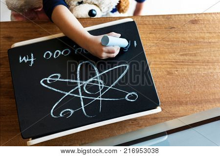 Little genius drawing up some science