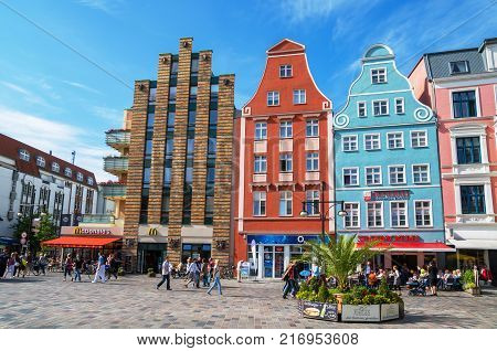 ROSTOCK GERMANY - JUNE 14 2011: People walking across the Kroepeliner street in the city centre