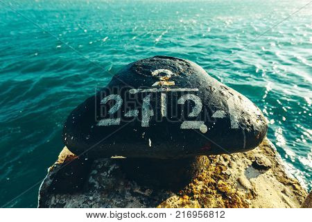 Knecht for mooring at the pier against the sea