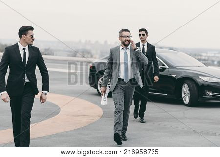 bodyguards protecting businessman on his way from car