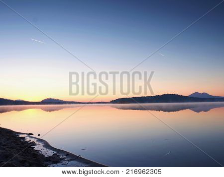 Autumn Sunrise. Deep Forest In A Beautiful Hilly Landscape Within Inversion Weather.