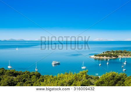 Panoramic View On Kosirina Beach Lagoon On Murter Island In Croatia, Anchored Sailing Boats And Yach