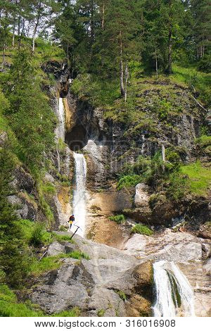 Climber In The Waterfall In Almbachklamm Pass In Berchtesgaden Germany