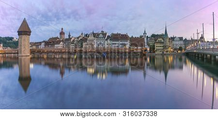 Town Hall, Water Tower, Wasserturm, And Traditional Frescoed Building Along The River Reuss At Sunri