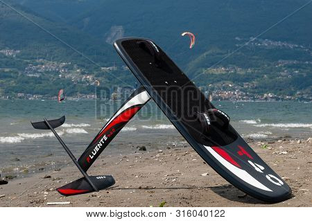 Lake Como, Italy - July 21, 2019. Windfoil Gear On A Beach Near Water. Windsurf Foiling Is New Style