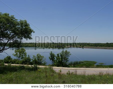 Wide Shot Of The Veteran Lake In Sulphur, Oklahoma Seen From The Road.