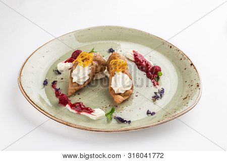 Fresh Italian Cannoli With Vanilla Cream And Strawberry Sauce On Green Plate Isolated On White Backg