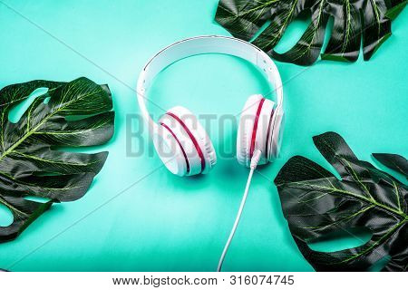 White Red Music Headphones On Technology Background Notbook Computer On A Blue Background. Happy Hol