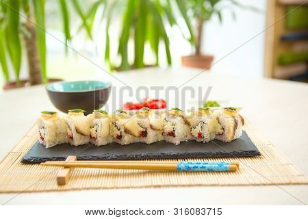 Maki Roll With Salmon, Popular Japanese Cuisine. Sushi Roll With Fish, Cream Cheese And Vegetables H