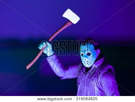 AUG 6 2019: recreation of a scene from the Nintendo NES 8-Bit Friday the 13th video game showing Jason Voorhees in day glow colors - Neca GameStop exclusive action figure