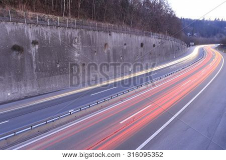 Car Light Trails On Highway During Twilight.
