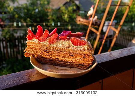 Touched By Evening Sunlight Delicious Piece Of Homemade Cake With Strawberry And Whipped Cream On A 
