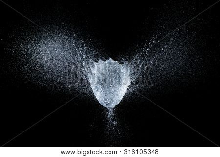 high-speed image of a balloon explosion filled with water at the exact moment of the explosion.