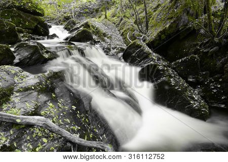 Coloursplash Of A Waterfall In The Woods At Watersmeet In Exmoor National Park