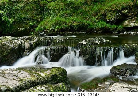 Long Exposure Of A Waterfall At Watersmeet In Devon