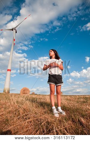 Windmills For Electric Power Production On The Field Of Cereal.