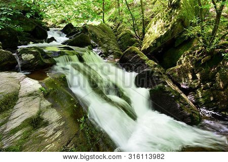 Long Exposure Of A Waterfall At Watersmeet In Devon