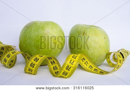 Sport Healthy Nutrition Green Apple And Yellow Measuring Tape On White Background