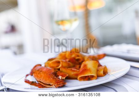 Pasta With Spiny Lobster And Tomato Sauce. Seafood Lunch At The Restaurant And A Glass Of White Wine