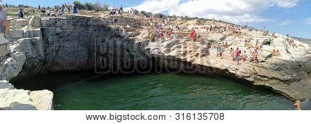Giola, Thassos, Greece - July 11, 2019: Tourists Bathing In The Giola. Giola Is A Natural Pool In Th