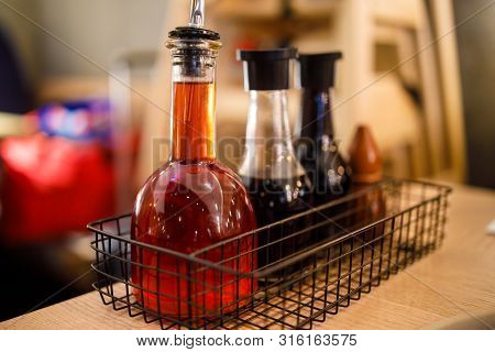 Chilli Oil, Soya Sauce Etc In Bottles On A Table