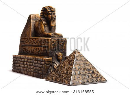 Sphinx Figurine And Pyramid Located On A White Background